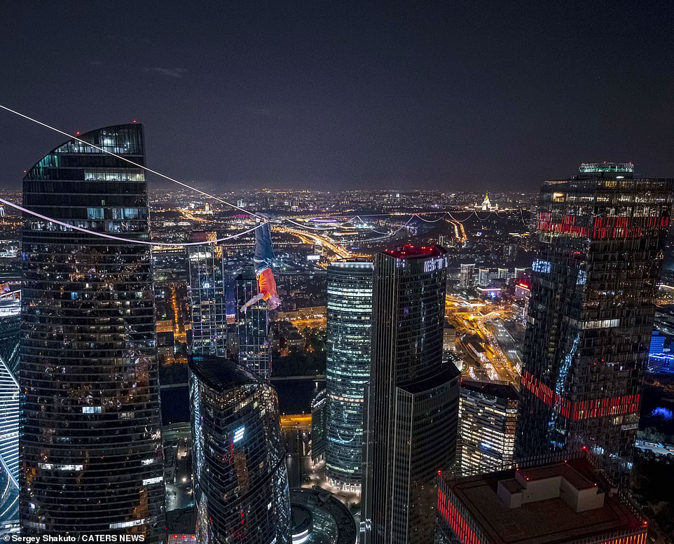 18337160-7451443-image-a-45_1568193823621 One of the athletes dangles from the rope by his feet. They wore harnesses but that would not have done much to reduce the heart rate at over 1,000ft above the deck