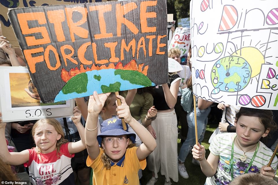 18703490-7484625-image-a-55_1568952874757 School children attended the protests with their parents. Many had spent the night before creating their signs