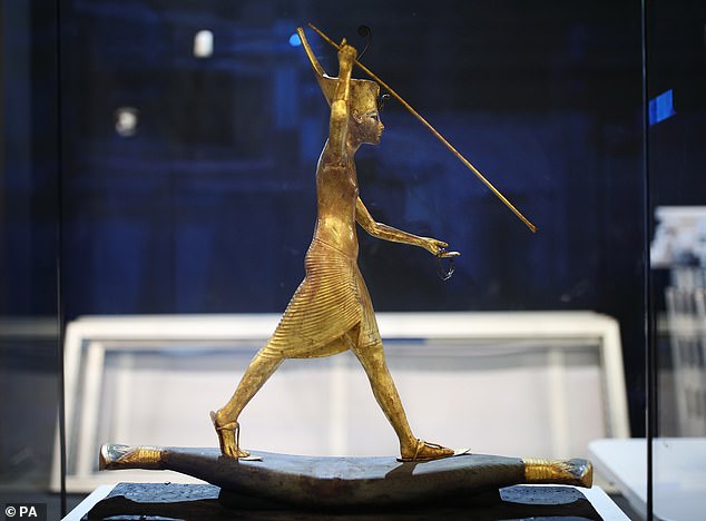 19190574-7527979-image-a-5_1570001257309 A gilded wooden figure of Tutankhamun on a Skiff, throwing a harpoon, dated in the reign of Tutankhamun 1336-1326 BC