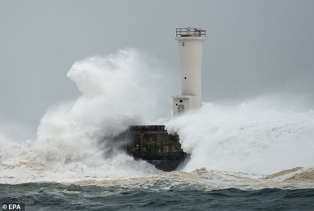 19624914-7565683-image-a-5_1570879619242 Surging waves generated by Typhoon Hagibis hit against a breakwater at a port in the town of Kiho on Saturday
