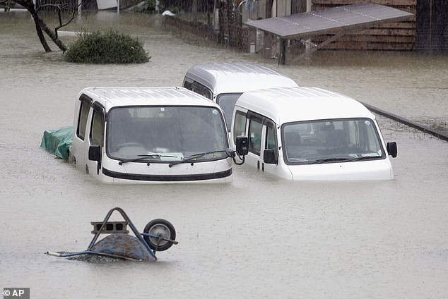 19624936-7565683-image-a-9_1570879647417 Cars submerged in water in a residential area hit by the dramatic typhoon in Ise, central Japan