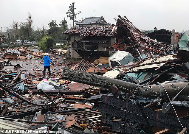 19627926-7565683-image-a-80_1570890177021 Rubble covers the ground in Ichihara, Chiba after harsh weather ripped through homes