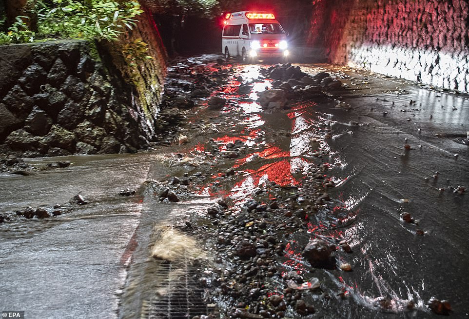 19632094-7565683-an_emergency_vehicle_drives_through_debris_on_a_flooded_road_dur-a-10_1570923421077 An emergency vehicle drives through debris on a flooded road during the evacuation of guests at the Osen Sanso Nakamura hotel in Sengokuhara, in Nakone province