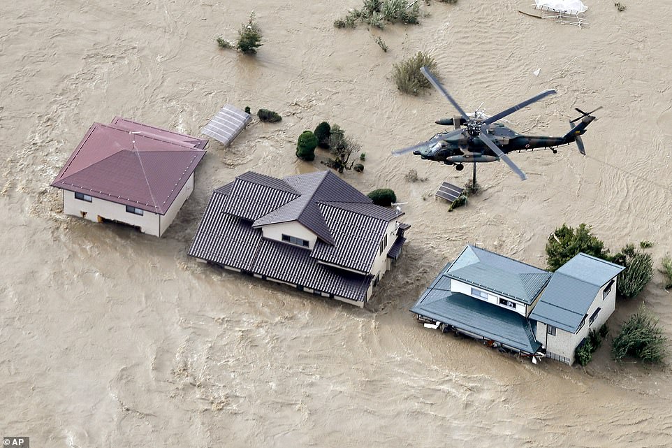 19641806-7567043-image-a-34_1570928112336 A Japan Self-Defense Force helicopter hovers above submerged residential area after an embankment of the Chikuma River broke because of Typhoon Hagibis