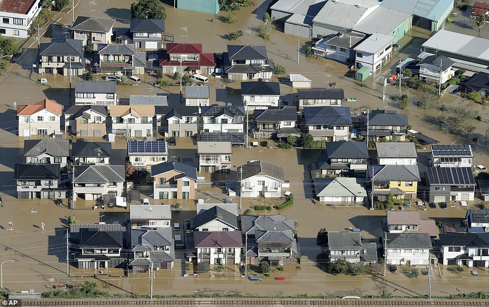 19641810-7567043-image-a-28_1570927963553 Houses are submerged after Typhoon Hagibis hit the area in Ashikaga, north of Tokyo, Japan. Some 376,000 homes were left without electricity, and 14,000 without running water