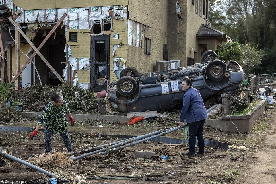 19651566-7567507-image-a-51_1570962161830 People recover items next to their house after it was damaged by a tornado shortly before the arrival of Typhoon Hagibis in Chiba, central eastern Japan