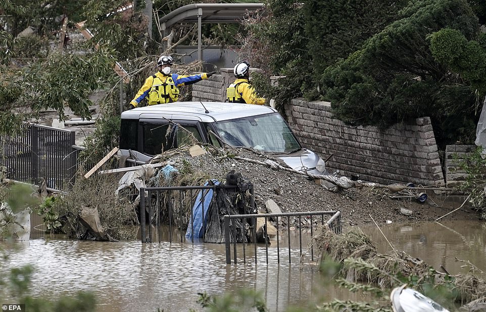19680298-7570251-image-a-26_1571037952192 Police rescuers search for missing people today in the Hoyasu area, which is flooded and devastated by Typhoon Hagibis