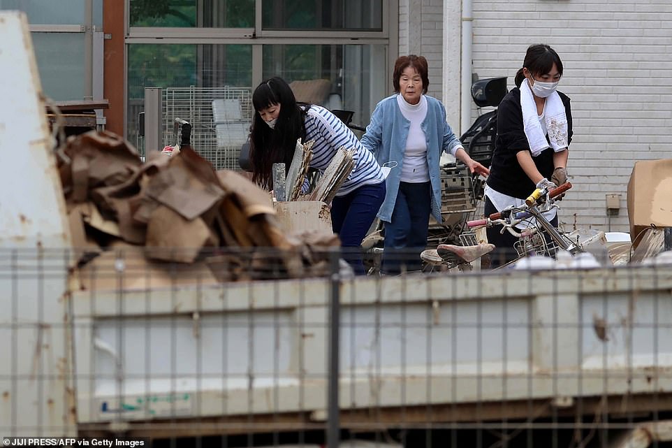 19680340-7570251-image-a-50_1571040947718 Residents moving household items outside their homes in flood-hit area in Kawagoe, Saitama prefecture today