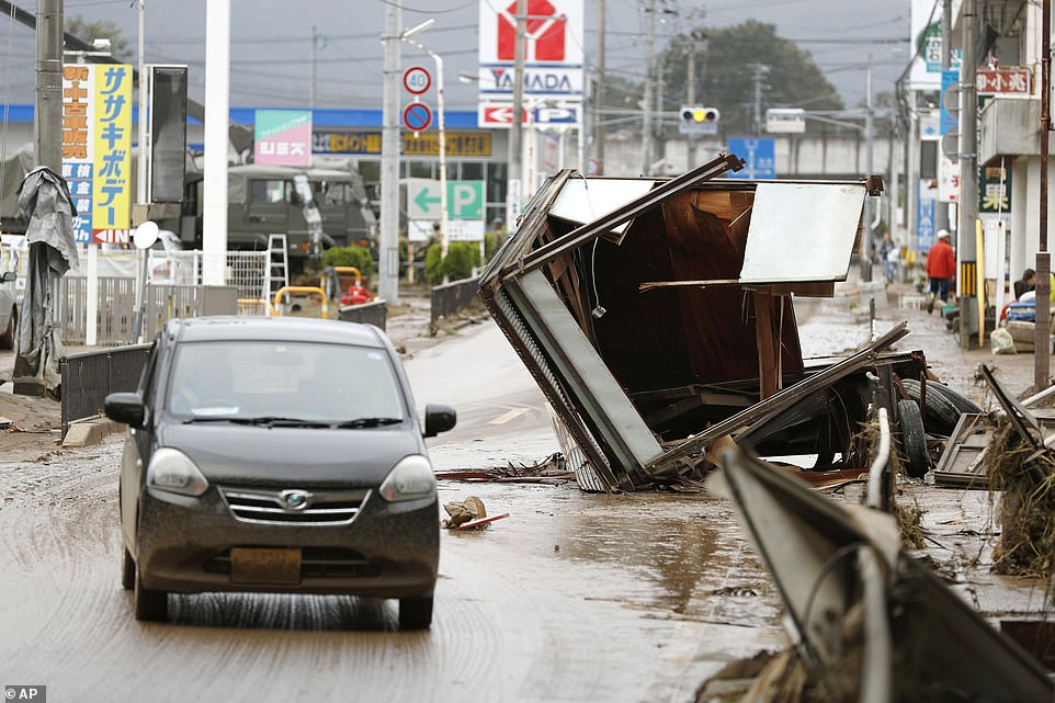 19680354-7570251-image-a-44_1571040918917 Debris caused by Typhoon Hagibis was left scattered across the roads and in streets in Motomiya, Fukushima prefecture, Japan, today