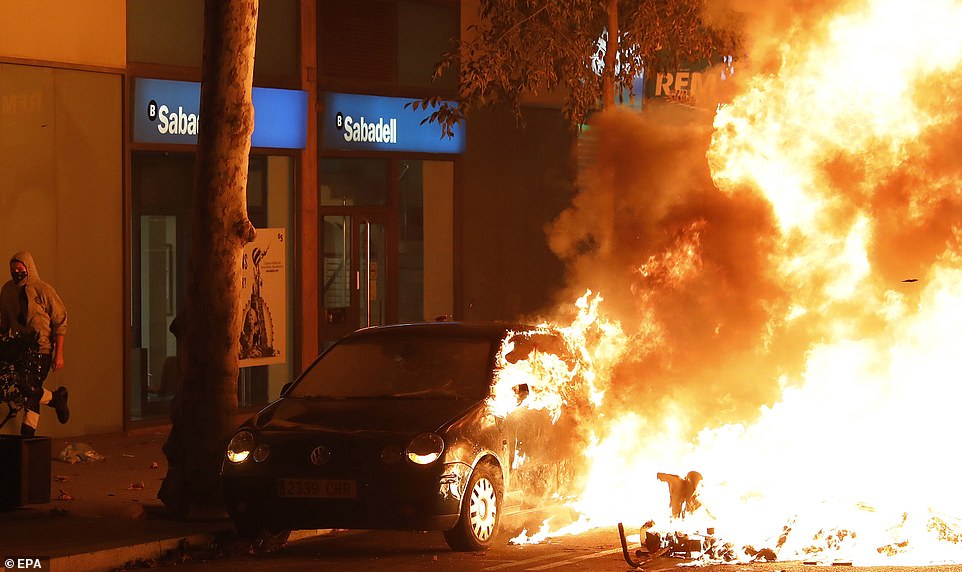 19813538-0-image-a-102_1571270026635 A car is consumed by flames during riots last night against the Spanish Supreme Court's ruling of multiple jail terms for pro-independence leaders, in Barcelona