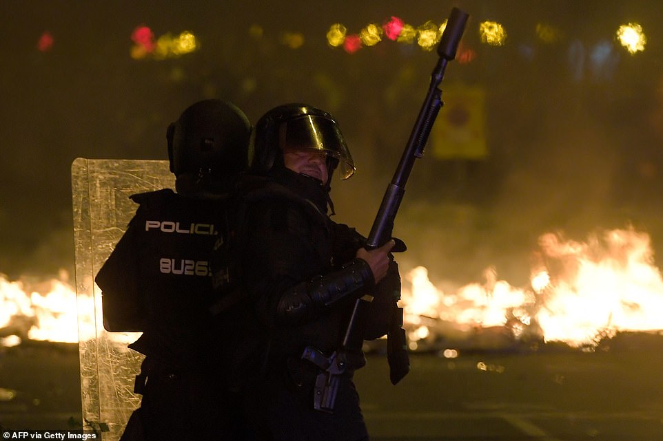 19813560-0-image-a-49_1571269589085 Anti-riot police officers stand guard in front of a barricade in flames during a demonstration called by the local Republic Defence Committees