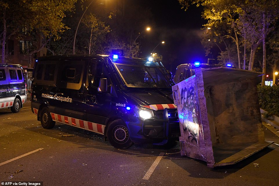 19813572-0-image-a-91_1571269981184 A police van removes a barricade during a demonstration in Barcelona last night, as violent clashes in the city continued