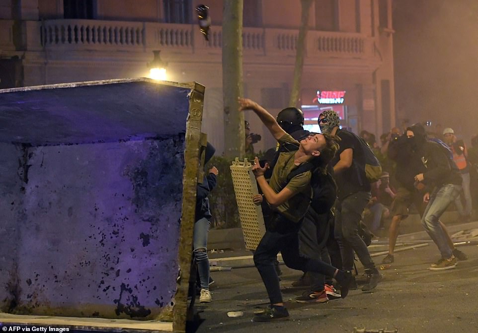19813592-0-image-a-87_1571269943870 Protesters clashed with riot squad officers, throwing missiles including stones and flares, repeating last Tuesday night's tactic of setting fire to piles of cardboard boxes and rubbish bins