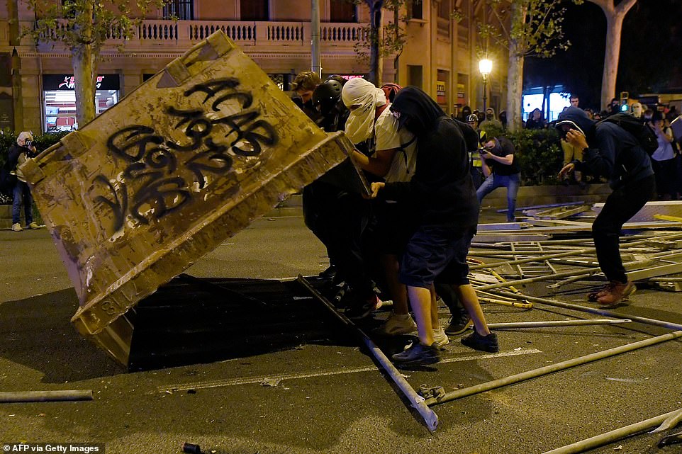 19813602-0-image-a-76_1571269878502 Protesters knock-over a container during a demonstration called by the local Republic Defence Committees (CDR) in Barcelona on October 16