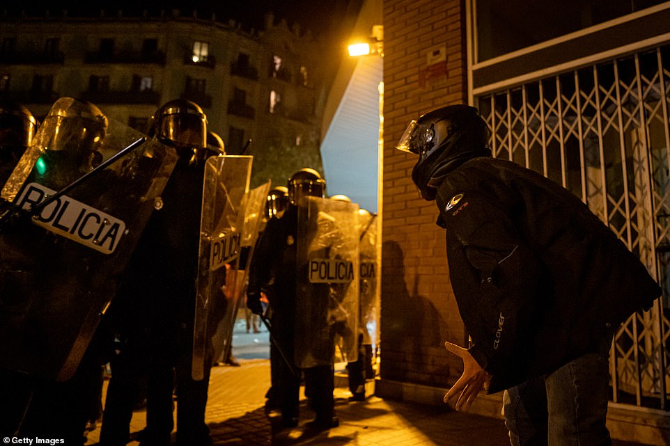 19814962-7581995-image-a-131_1571271690080 A protester argues with police officers on October 16 in Barcelona, Spain as the violent clashes continued in the region