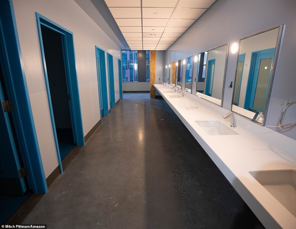 20783916-0-image-a-28_1573254018974 Amazon shared a gallery of pictures showing how construction of the eight-story shelter is coming along. The bathrooms are starting to take shape in the shelter