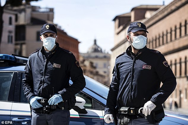 25914250-8109893-italian_police_officers_wearing_protective_masks_check_motorists-a-109_1584121346528 Italian police officers wearing protective masks check motorists and pedestrians due to the coronavirus emergency in Rome
