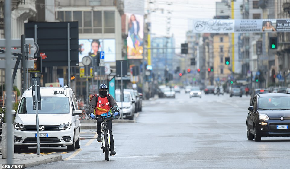 25967942-8111805-a_food_delivery_driver_cycles_along_nearly_deserted_streets_in_m-a-7_1584203241054 A food delivery driver cycles along nearly-deserted streets in Milan, Italy, after the Italian government announced measures to slow the spread of deadly coronavirus