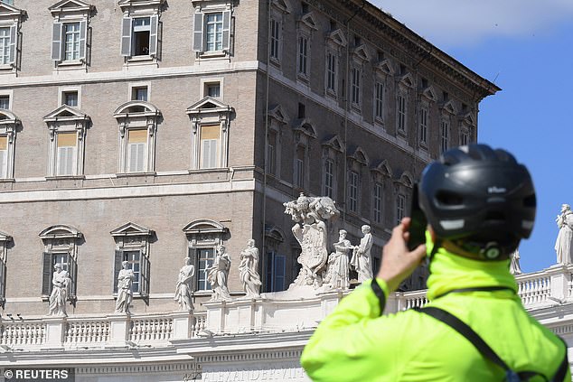 25992604-8113675-image-a-26_1584274236720 A person tries to take picture of the Pope Francis at St Peter's Square on the sixth day of an unprecedented lockdown across all of Italy