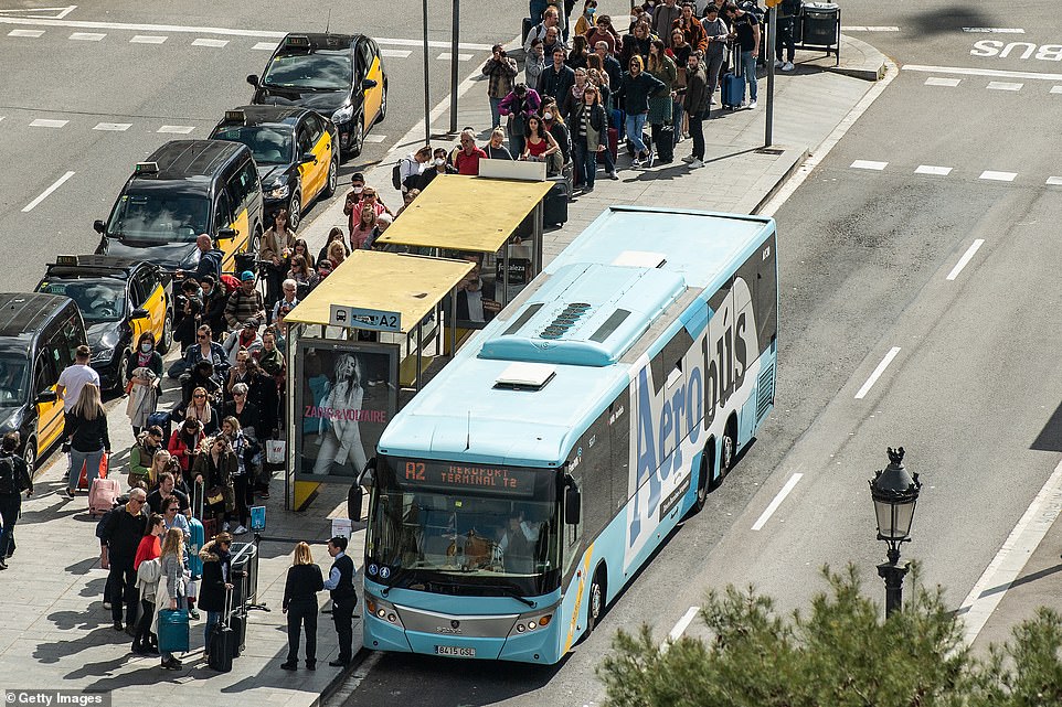 25995060-8114189-image-a-31_1584285141207 Tourists gather at a bus station for services towards the airport on March 15, 2020 in Barcelona, Spain. Total infections in Spain have approached 8,000 and the Health Ministry said the nation has recorded 288 deaths since the start of the pandemic, up from 136 on Saturday