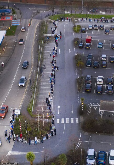 26234870-8137409-image-a-28_1584780812808 Police were yesterday forced to step in to stop selfish stockpilers from barging past pensioners and ransacking supermarket shelves. Pictured are hundreds of shoppers queueing a Tesco this morning at 6am