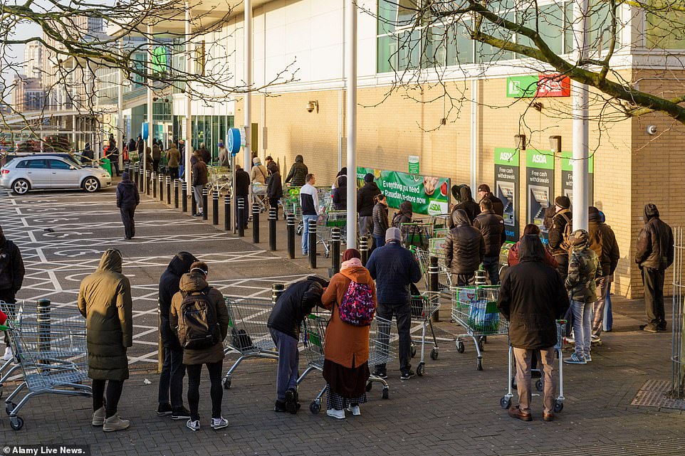 26236190-8137409-image-a-52_1584787270228 A huge queue of people is seen queueing outside an Asda in Middlesex while people continue to panic buy amid the coronavirus pandemic
