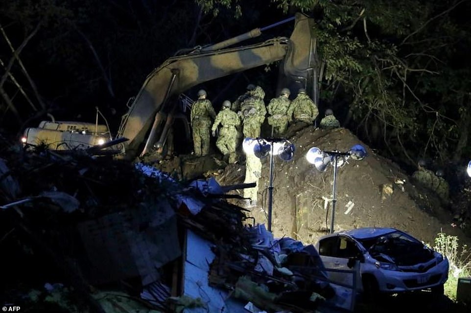 4214028-6145357-rescue_operations_continued_throughout_the_night-a-2_1536393750047 Rescue operations continued throughout Friday night, as personnel shone bright lights on to mud-caked areas to find survivors