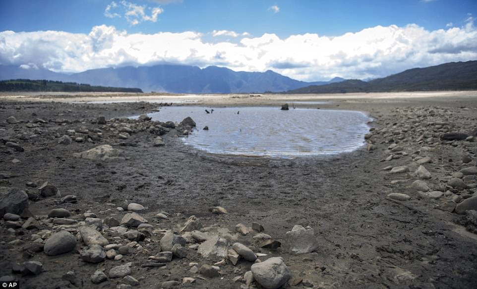 A warning of 'the threat to social order' in the wake of the water crisis was predicted by Moody's credit ratings agency. Pictures show how water has receded at one of the city's key supplies, the Theewaterskloof dam