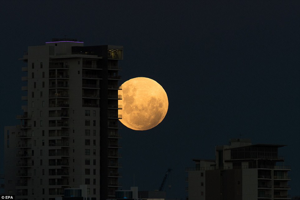 A super blue blood moon rises over the city of Perth in Western Australia. Enthusiasts have been waiting 150 years to see the triple lunar event where a total lunar eclipse will turn the moon a brooding, dark red, coinciding with both a super moon and a rare blue moon