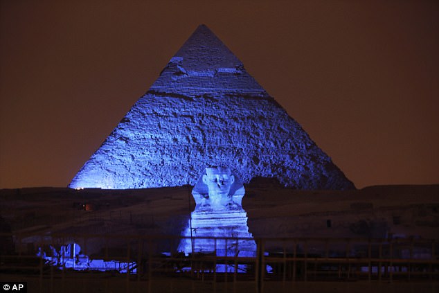 The tomb was discovered near the country's famed pyramids at the Giza plateau just outside Cairo. Pictured: the Sphinx and a pyramid