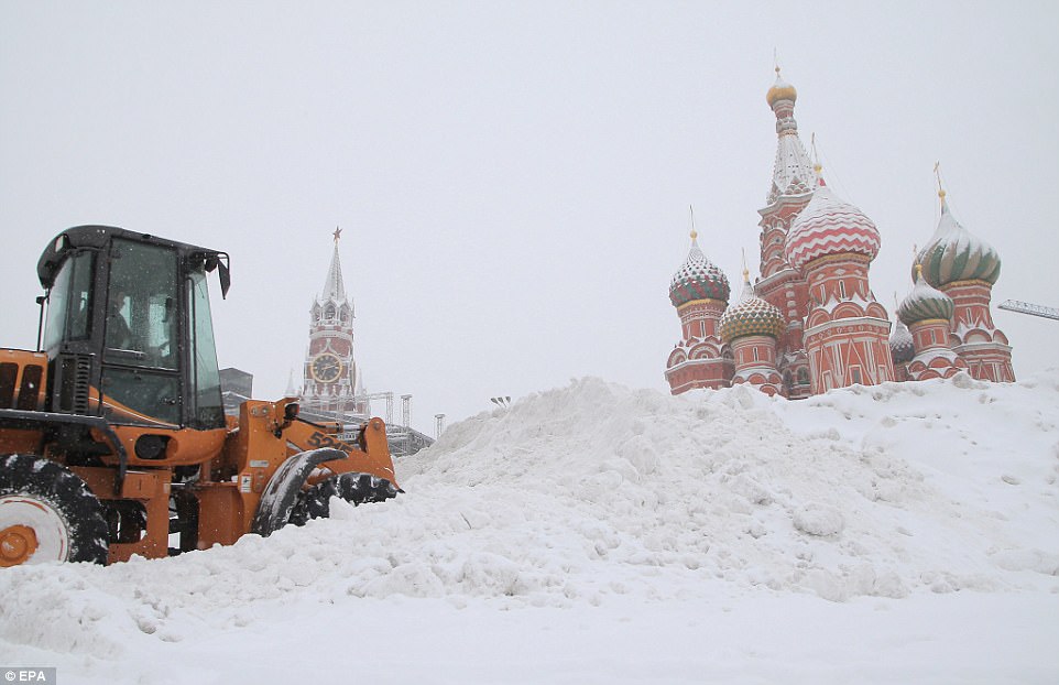 A digger clears snow from Red Square after the weather caused a fatal disaster than also injured several people yesterday with authorities warning the conditions will worsen 