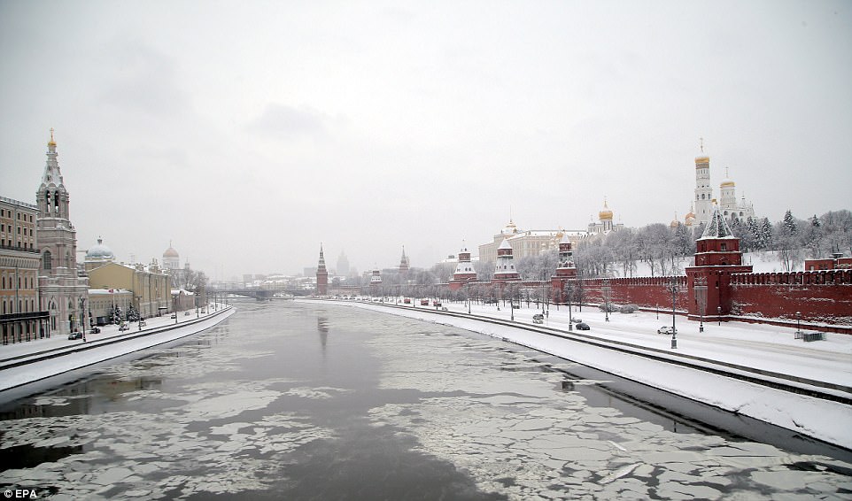 Drivers were warned to stay off the roads as the city centre's Red Square was covered in ice and snow and windy brought power lines down across Moscow 