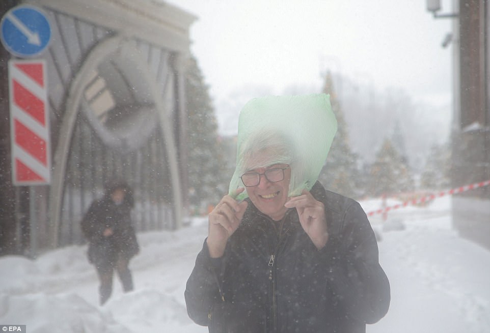 This man opted for a plastic bag instead of the traditional ushanka favoured by the police as he braved the capital's freezing conditions  
