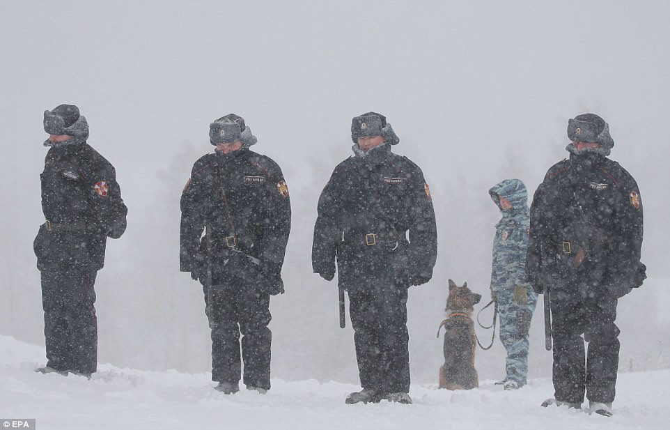 Officers were seen braving the freezing conditions with their trademark ushanka hats as emergency services warned people to stay off the roads during the icy weather 