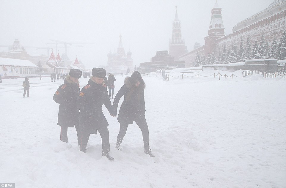 Federal agency police were seen struggling through the snow in the capital as flights were delayed and cancelled across the Russian capital 