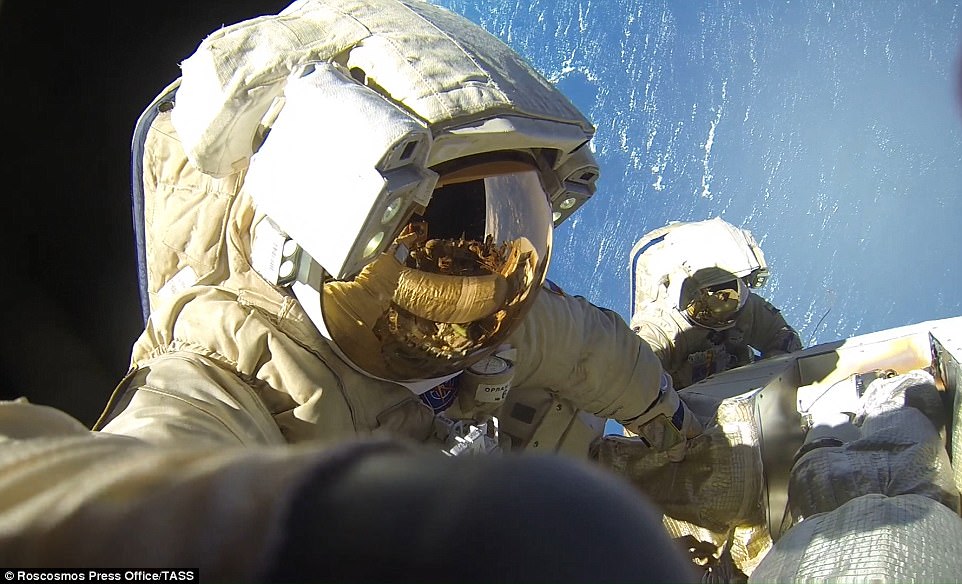 Stunning pictures show the two cosmonauts working methodically to install the antenna with the blue hue of planet earth illuminating their expedition. The two cosmonauts opened the hatch to the Pirs docking compartment to begin the spacewalk at 10:34am EST. They re-entered the airlock and closed the hatch at 6:47pm EST