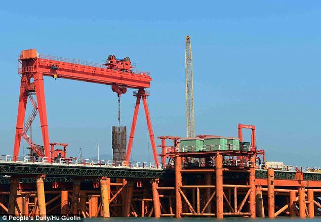 This picture taken in 2015 shows one of the drillships putting a pillar into the seabed. The workers successfully laid the foundation of the bridge last November with 1,895 pillars