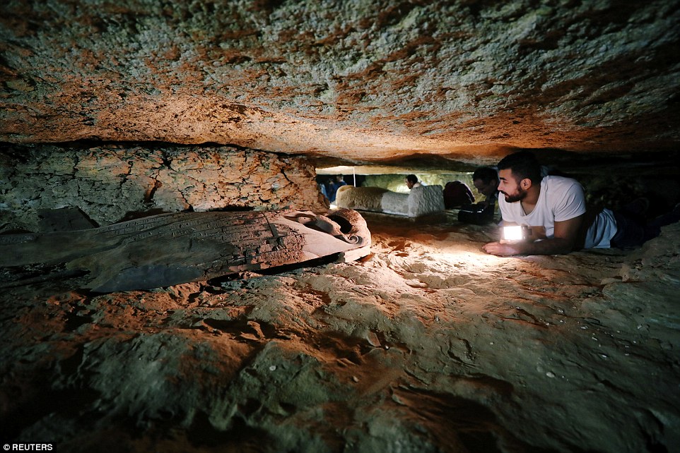 An ancient cemetery with 40 mummies inside body-shaped stone coffins and a necklace charm bearing the hieroglyphic inscription 'happy new year' has been found in the Nile Valley 