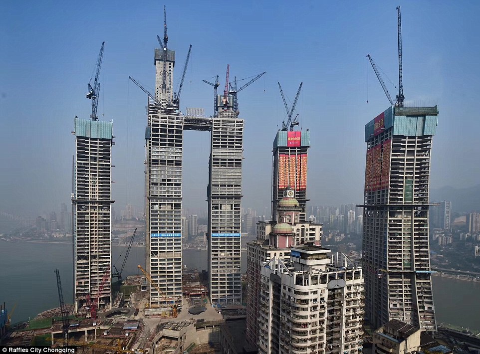 49f9557400000578-5469297-image-a-30_1520439034312 Scenic: The group of skyscrapers tower over Chongqing's Chaotianmen area where the Yangtze River and Jialing River merge