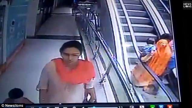 The couple then begin riding the escalator. Witnesses say at that point, the man asked his wife for a selfie