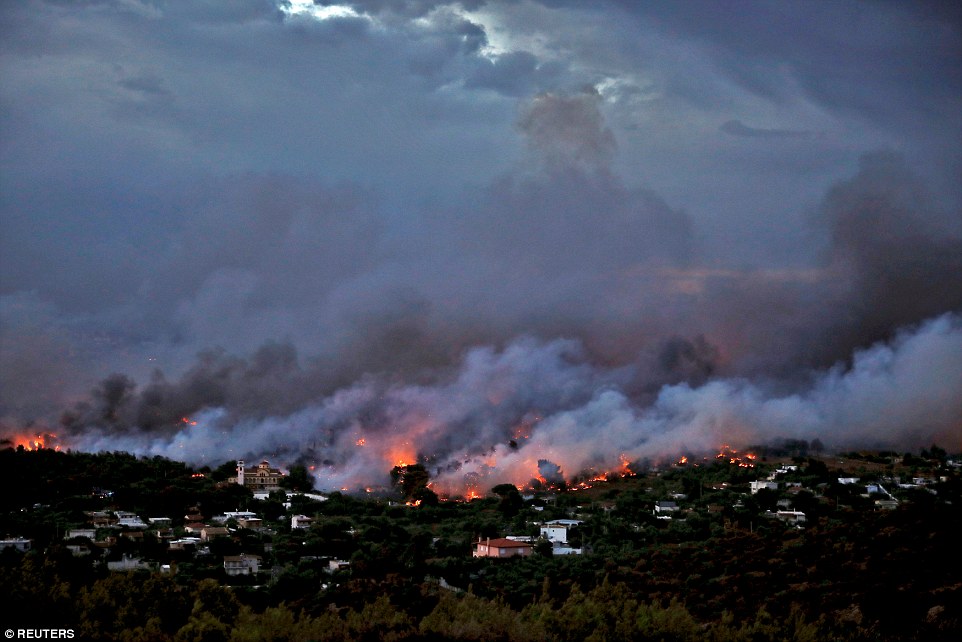 There are reports of tourists retreating to beaches and people drowning in the sea while trying to escape the flames engulfing woodland around the Athens region