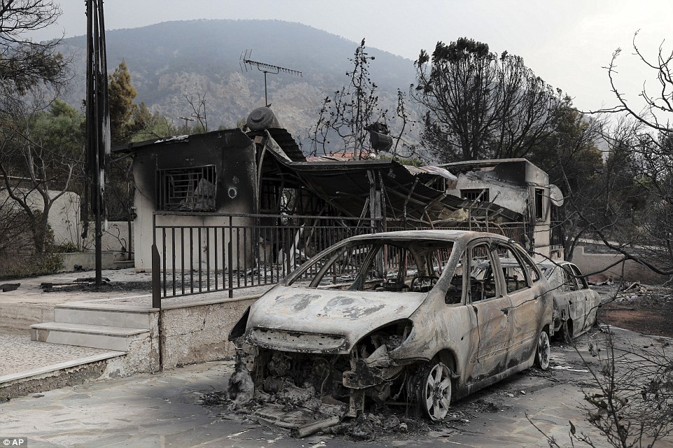 Cars and buildings were left in charred ruins as flames ripped through the Kineta village area. The death toll is expected to climb today
