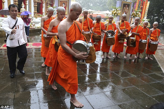 Coach Ekkapol Chanthawong, 25, (pictured front) led the way in the ceremony