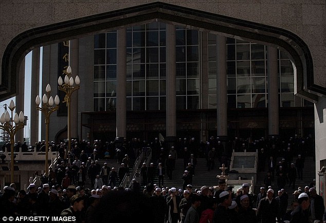 Ethnic Hui Muslim men leaving Laohuasi Mosque after Friday prayers in Linxia on March 2