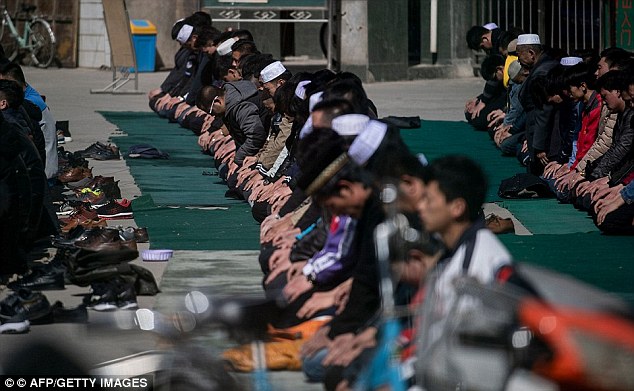 Ethnic Hui Muslim men praying at Nanguan Mosque during Friday prayers in Linxia, Gansu