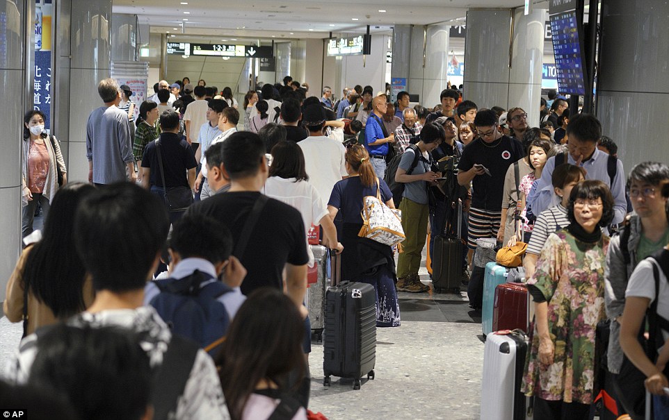 4fdd23eb00000578-6145357-image-a-7_1536395573517 Stranded passengers queue up in lines to wait for their flights at New Chitose Airport, Sapporo, Hokkaido, northern Japan. The regional airport was beginning to resume operations after hundreds of flights had been cancelled, stranding thousands of travellers, due to Thursday's power outage and light quake damage