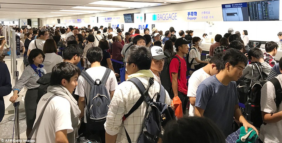 4fe0a80800000578-6145357-image-m-44_1536405845482 Passengers crowd around the terminal as they check-in at New Chitose Airport in Hokkaido prefecture after a powerful 6.6-magnitude quake rocked the northern Japanese island of Hokkaido on September 6