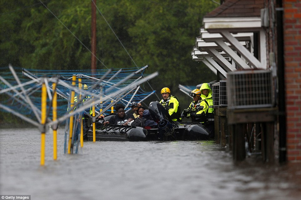 502cf1be00000578-0-image-a-34_1536976088721 Firefighters use a boat to rescue three people from their flooded home during Hurricane Florence in New Bern
