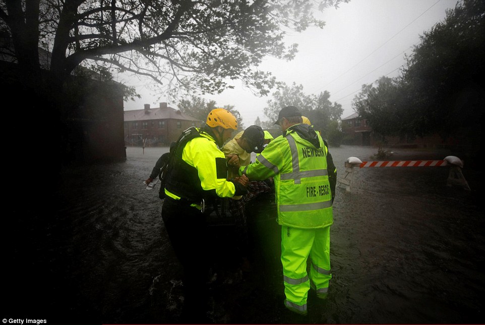 502cf1fe00000578-0-image-a-37_1536976120466 New Bern firefighters use a boat to rescue people from their flooded homes during Hurricane Florence