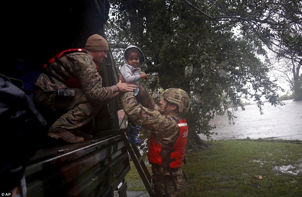502f027d00000578-0-image-a-18_1536975756068 Rescue team members Sgt. Matt Locke (left) and Sgt. Nick Muhar (right) evacuates a family from floodwaters in New Bern